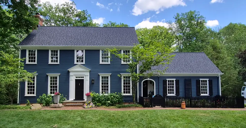 Navy painted house exterior with white trim by our painters in Northeast Ohio