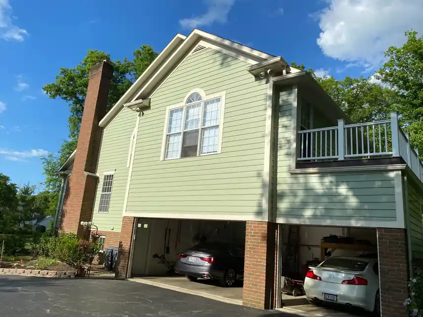 House painter in Aurora, Ohio for garage-side exterior painting with siding and trim protection