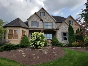 Home painting in Aurora, Ohio with exterior siding and trim updates that complement stone details