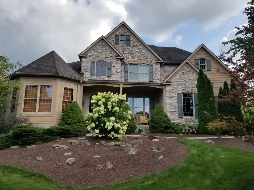 Home painting in Aurora, Ohio with exterior siding and trim updates that complement stone details