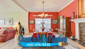 Freshly painted dining room with bold red accent wall representing house painting services in Brecksville, Ohio by Chagrin Falls Painting Company