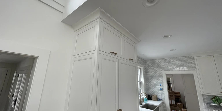 White painted kitchen cabinets and crown molding