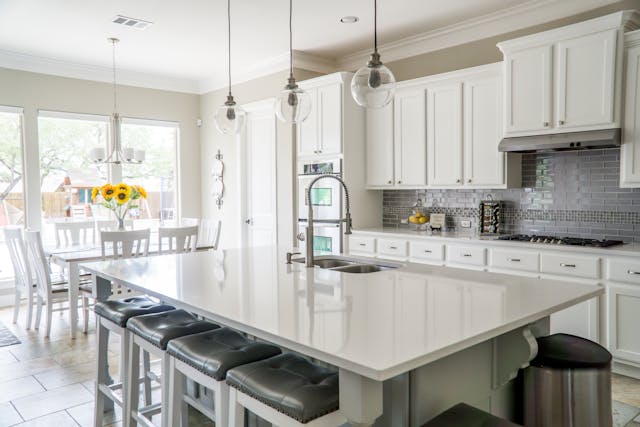 White cabinets in a Parma, Ohio kitchen after professional cabinet painting by Chagrin Falls Painting.