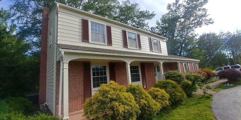 Two-story colonial with freshly painted trim and maroon shutters in Orange Village, Ohio