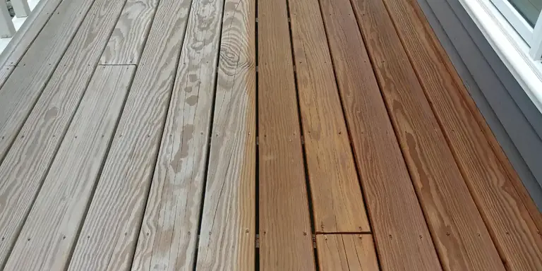 Deck boards half weathered gray and half refinished with warm stain, deck refinishing in Northeast Ohio