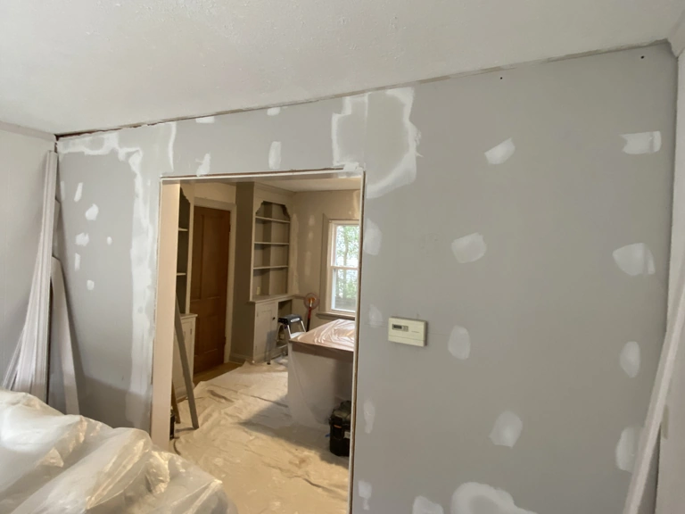 Wall patched and skim-coated with joint compound before its finish coats, drywall repair in a Northeast Ohio home