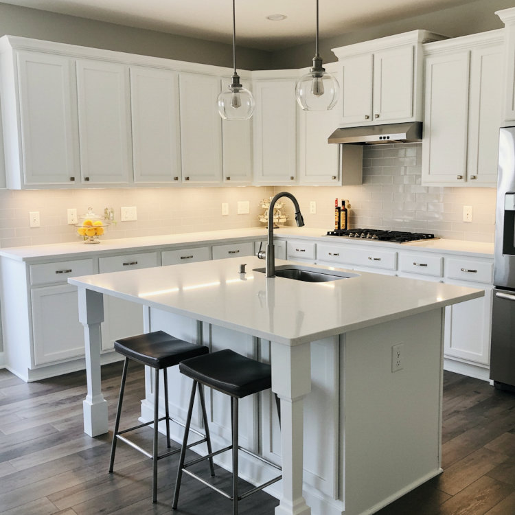 Finished kitchen cabinet makeover with freshly painted white cabinets and new hardware in Ohio home