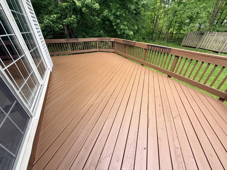 Large wood deck freshly stained in a cedar tone beside a Northeast Ohio home, deck staining by Chagrin Falls Painting