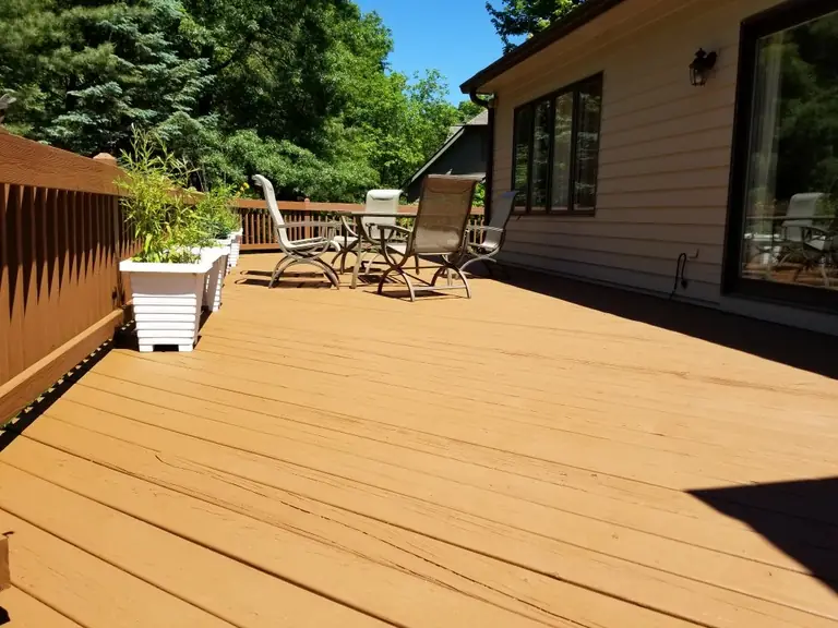 Wood deck with fresh solid-color stain and patio furniture, deck staining in Northeast Ohio