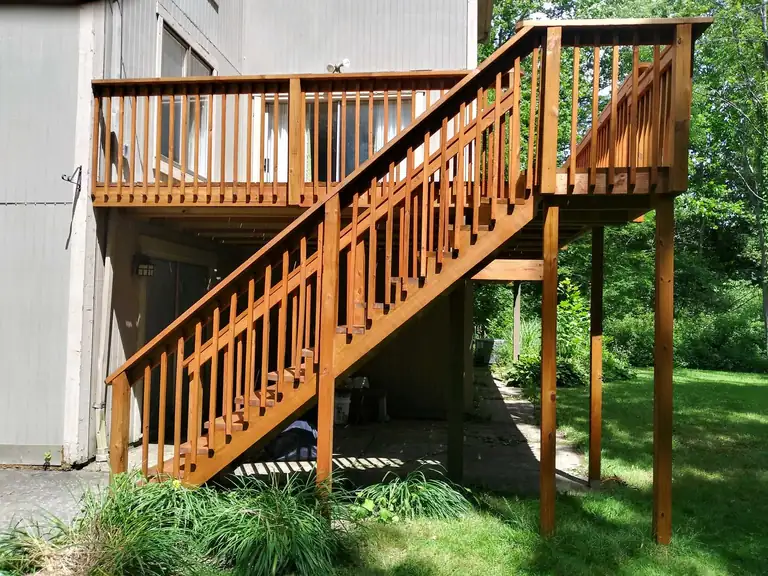 Elevated wood deck and stairs restained in a warm cedar tone, Northeast Ohio
