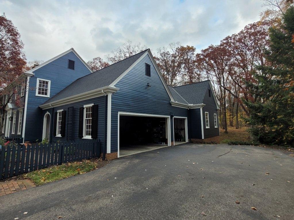 Blue two-story house with freshly painted siding and trim in Northeast Ohio
