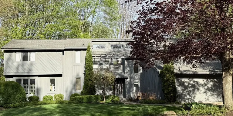 Gray contemporary home with vertical siding after exterior painting