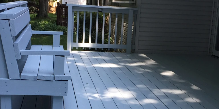 Wood deck and built-in bench painted light gray in Willoughby, Ohio