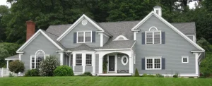Gray two-story home with blue-gray vinyl siding and white trim representing residential house painting services in Brecksville, Ohio
