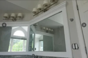 Interior residential painting in a bathroom with smooth wall coverage, crisp trim lines, and clean cut-in around fixtures and mirrors.