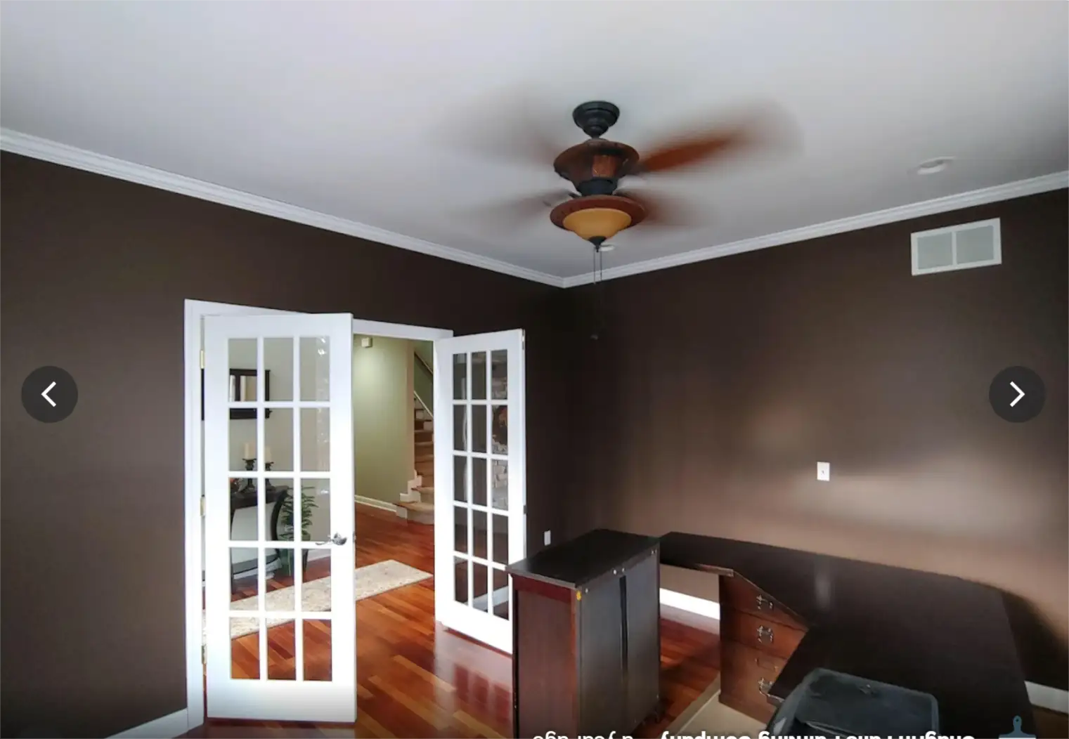 Interior residential painting in a bedroom with dark walls, smooth coverage, and clean white trim lines.