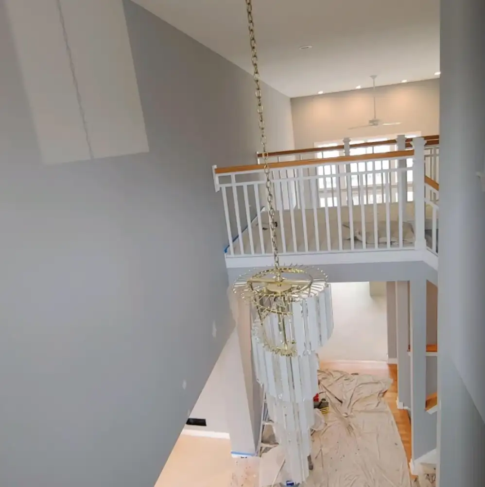 Interior residential painting in a hallway and stairwell with smooth wall coverage, clean ceiling lines, and crisp trim edges.