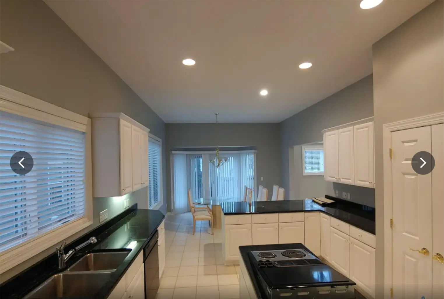 Interior residential painting in a kitchen with smooth wall coverage, clean ceiling lines, and crisp edges around cabinets and trim.