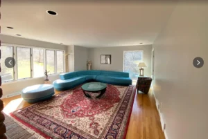 Interior residential painting in a bright living room with smooth wall coverage, clean ceiling lines, and a fresh neutral finish.