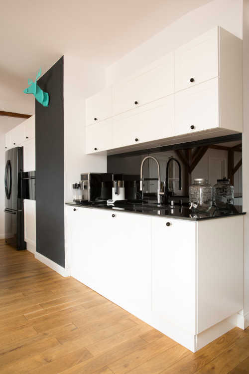 Bright kitchen with freshly painted cabinets by home painters near me.