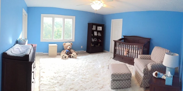 Nursery painted bright blue with white trim in Pepper Pike, Ohio