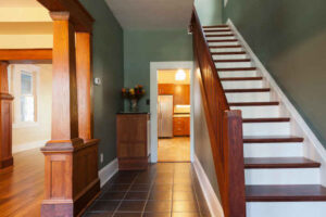 A well-painted home entry corridor with stairs.