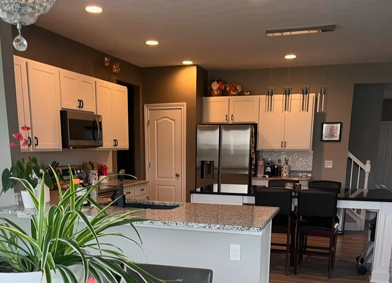 Cabinet refinishing in Parma OH with white kitchen cabinets and a clean, modern finish