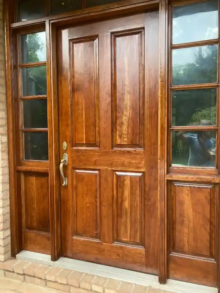 Detailed view of a stained wood front door with sidelights in Cleveland.