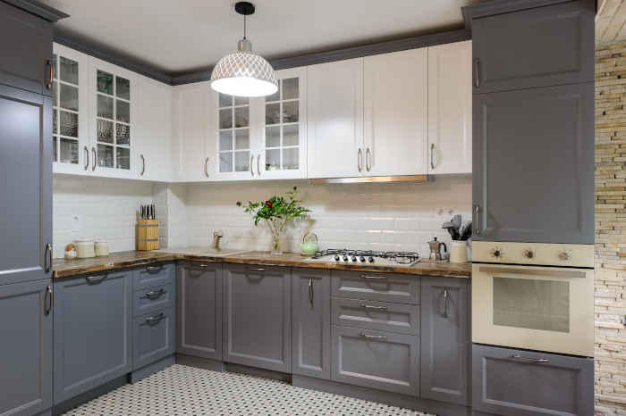 A combination of white and gray cabinets painted to create a modern and timeless look.