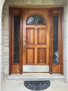 Stained wood front door with sidelights painted by Chagrin Falls Painting Company, Ohio